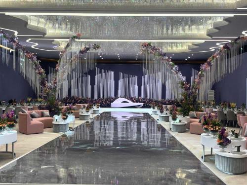 a rendering of a banquet hall with tables and flowers at Pullman Doha West Bay in Doha