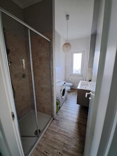 a bathroom with a shower and a toilet and a sink at Appartamenti di Claudia, Locazione turistica in Spoleto