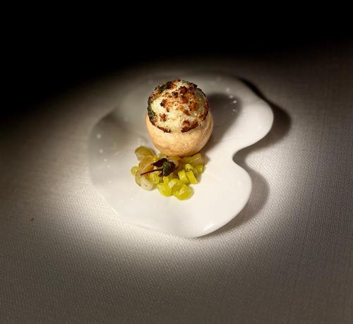 a white plate with an ice cream and grapes on it at The Seven Hotel in Esch-sur-Alzette