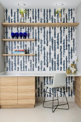a room with shelves with blue vases and a chair at Residence Inn by Marriott San Juan Isla Verde in San Juan