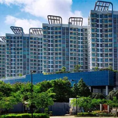 a group of tall buildings in a city at Mactan Newtown 8 Boulevard Deluxe Ocean View in Lapu Lapu City