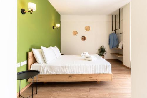 a bedroom with a bed and a green wall at Senaon Urban Living City Center in Heraklio Town
