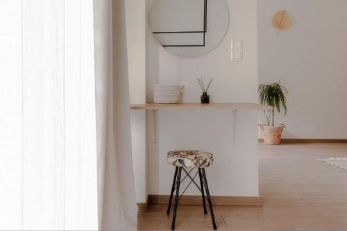 a stool in a room with a table and a mirror at Senaon Urban Living City Center in Heraklio Town