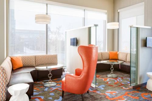 a waiting room with orange chairs and tables at Residence Inn by Marriott National Harbor Washington, D.C. Area in National Harbor