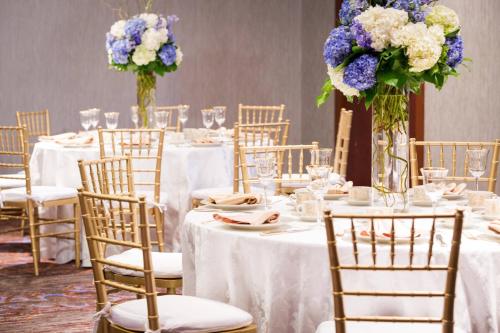 a table set up for a wedding with purple and white flowers at Residence Inn by Marriott National Harbor Washington, D.C. Area in National Harbor