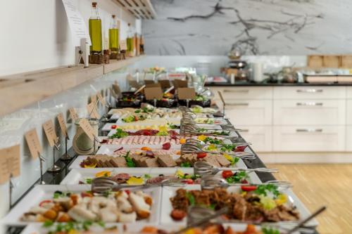 a buffet line with many different types of food at Hotel Shuum Boutique - Destigo Hotels in Kołobrzeg