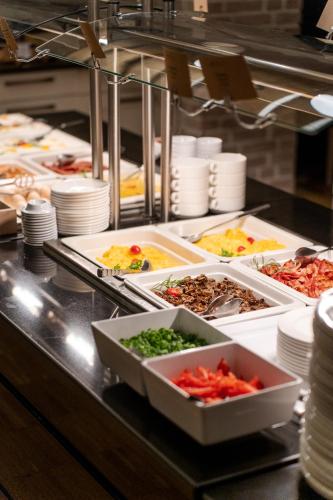 a buffet line with many different types of food at Hotel Shuum Boutique - Destigo Hotels in Kołobrzeg