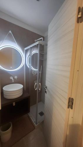 a bathroom with a shower and a toilet and a mirror at La Maison De Poupée in Bari