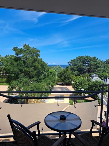 a patio with a table and chairs on a balcony at Strandhotel Prinz von Preussen in Zinnowitz