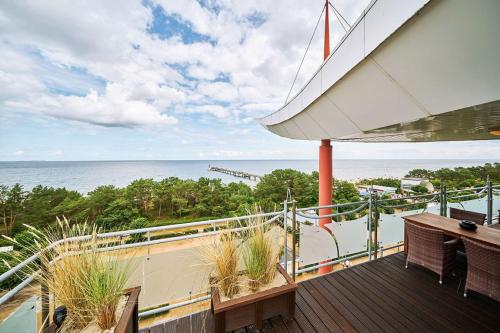an outdoor deck with a view of the ocean at Strandhotel Prinz von Preussen in Zinnowitz