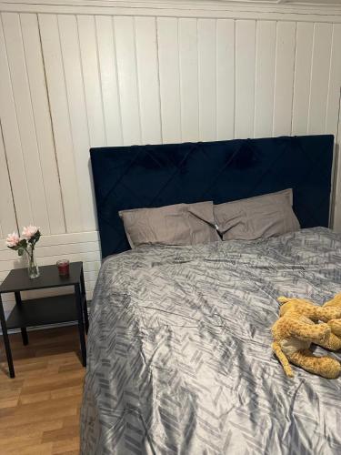 a blue bed with a stuffed animal on it at Huttwil in Huttwil