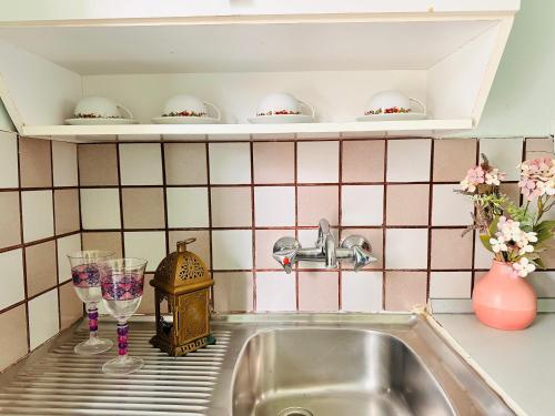 a kitchen counter with a sink and a cupboard at Infinity blue beach apartments - Renovated Apartments 2 Minutes from the Sea & Pool with Scenic Views in Tsilivi