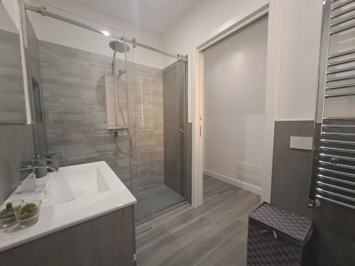a bathroom with a shower and a white sink at Villa Elios Adriana with pool by Casa in mente in Lascari