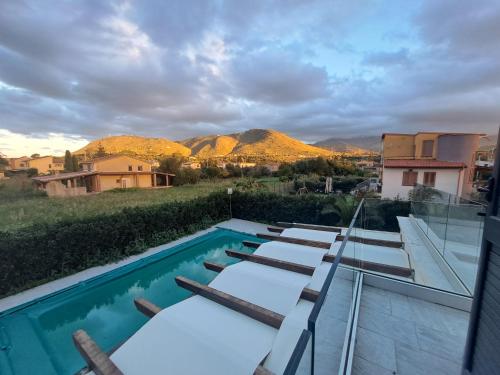 a swimming pool with a view of the mountains at Villa Elios Adriana with pool by Casa in mente in Lascari