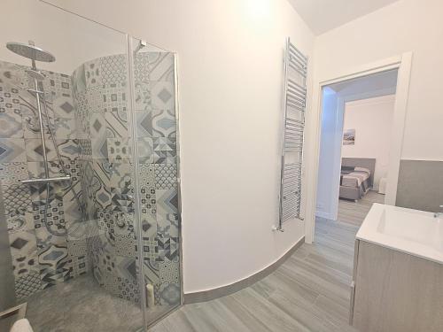 a bathroom with a glass shower and a sink at Villa Elios Adriana with pool by Casa in mente in Lascari