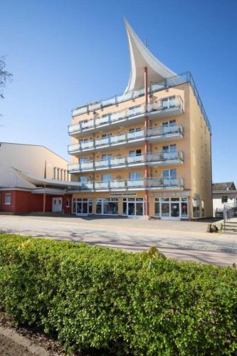 a large building with a pointed roof at Strandhotel Prinz von Preussen in Zinnowitz