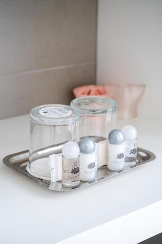 a tray with four glass containers on a table at By the Sea - Nazaré in Nazaré