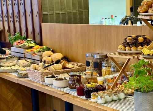 a buffet of food on a table with bread and pastries at XYZ eXtreme You Zen in Szczyrk