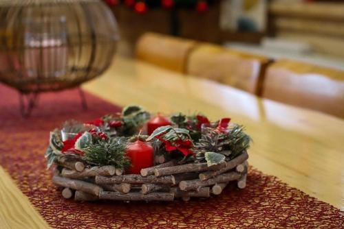 a wicker basket with tomatoes and greens on a table at Nonićeva Hiža in Fužine