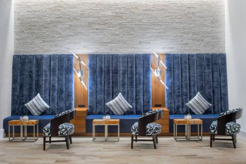 a waiting room with blue curtains and chairs at Residence Inn by Marriott Stamford Downtown in Stamford