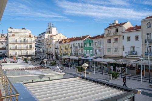 a group of buildings in a city with stairs at By the Sea - Nazaré in Nazaré