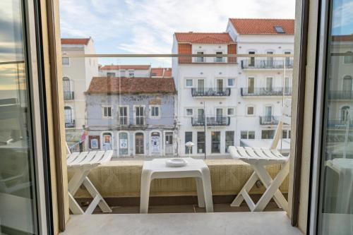 a balcony with a view of a building at By the Sea - Nazaré in Nazaré