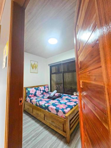 a small bedroom with a bed in a room at Mountain Sunctuary-F1 2 Bedroom with nature view in Baguio