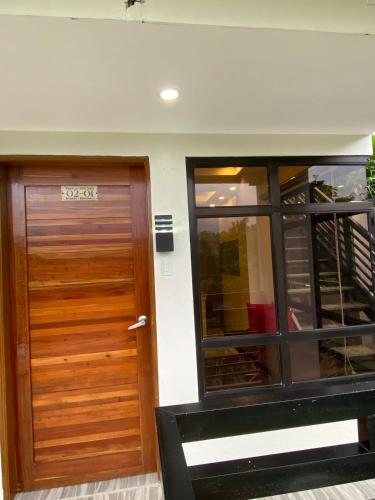 a front door of a house with a sign on it at Mountain Sunctuary-F1 2 Bedroom with nature view in Baguio