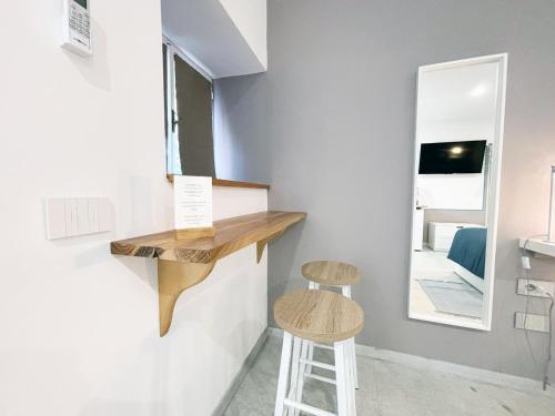 a stool in a room with a counter and a mirror at La Bouganville in Assisi
