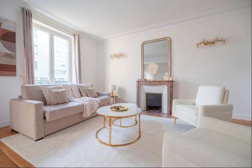 un salon avec un canapé, une table et un miroir dans l'établissement CIA - Champs Élysées Delight, à Paris