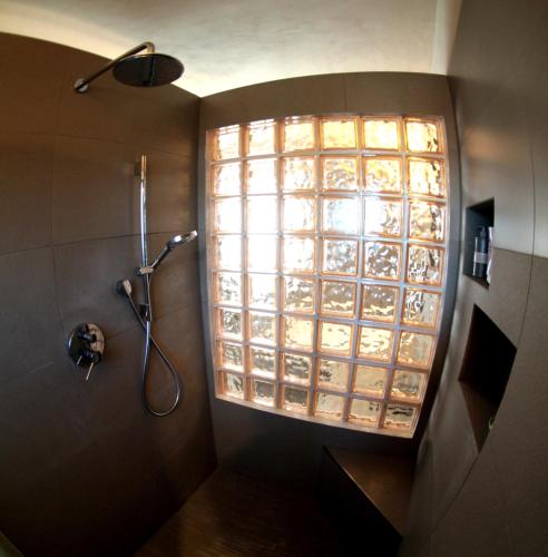 a shower in a bathroom with a large window at Oasi Brembate Bed and Breakfast in Brembate