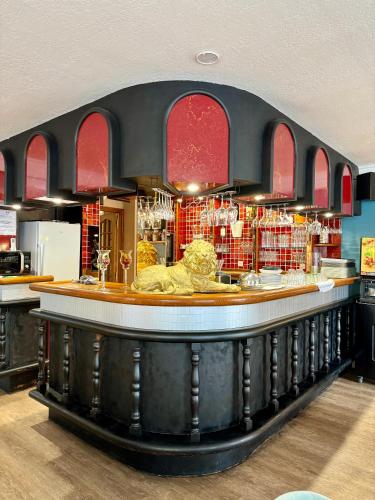 a bar with a lion sitting at the counter at Logis Hôtel de la Poste in Vitry-le-François