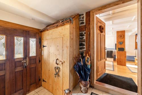 a room with wooden walls and doors with umbrellas at Schuler-Haus in Balingen