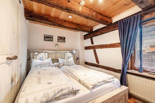 a large bed in a room with wooden ceilings at Schuler-Haus in Balingen