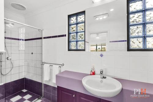 a white bathroom with a sink and a shower at Amazing Location with Ocean View in Cowes