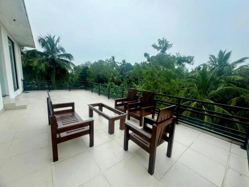 a group of chairs sitting on top of a balcony at Pearl White Residency-HOTEL in Polonnaruwa