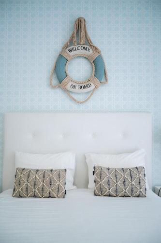 a bedroom with a bed with a sign on the wall at By the Sea - Nazaré in Nazaré