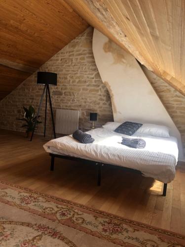 une chambre avec un lit dans un grenier dans l'établissement Les 3 voeux, à Druyes-les-Belles-Fontaines