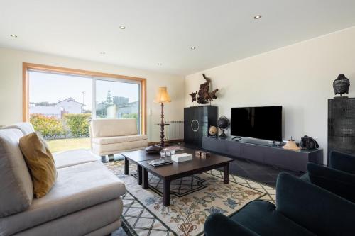 a living room with a couch and a table at Portugal Active Hábito's Lodge in Viana do Castelo