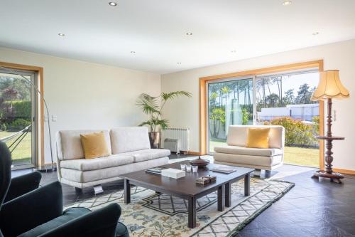 a living room with two couches and a coffee table at Portugal Active Hábito's Lodge in Viana do Castelo