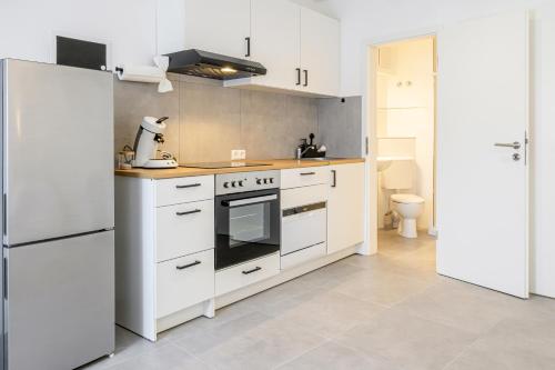 a kitchen with white appliances and a white refrigerator at EasyOne Apartments in Frankenthal