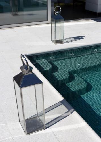 a swimming pool with two lights on the side of a building at Portugal Active Hábito's Lodge in Viana do Castelo