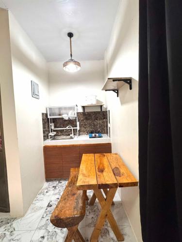 a kitchen with a wooden table in a room at Mountain Sunctuary-LH Solo Unit for couple in Baguio
