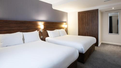a hotel room with two beds and a tv at Holiday Inn Liverpool City Centre by IHG in Liverpool