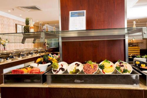 a buffet line with many different types of food at Sunday Millennia Hotel in Riyadh