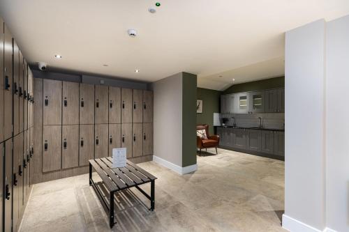 a gym with lockers and a bench in a room at Rock Mill 1 Bed Apartment 13 in Stoney Middleton