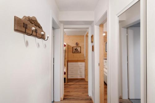 a hallway of a home with white walls and wood floors at A casa di Anna in Madesimo