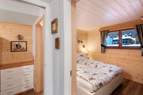 a small bedroom with a bed and a window at A casa di Anna in Madesimo