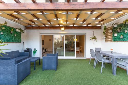 a patio with blue chairs and a table at Tide Terrace Duplex by Portugal Active in Viana do Castelo