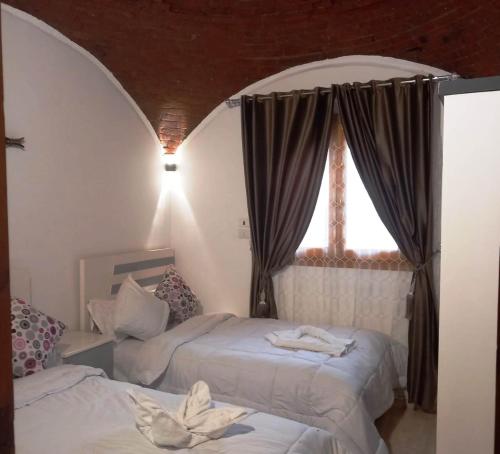 Ένα ή περισσότερα κρεβάτια σε δωμάτιο στο Upper Egypt House